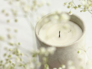 white candle in clear glass holder