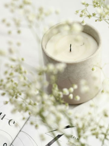 white candle in clear glass holder